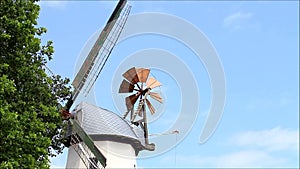 Landscape old grain mill against blue sky