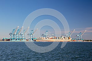 Landscape orientation of Freighter ship and cranes at loading dock