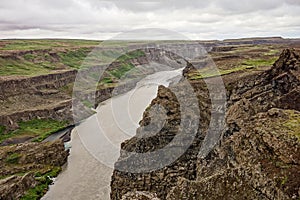 Landscape panorama near the  Hafragilsfoss waterfall in Iceland in overcast weather and rocky cliffs