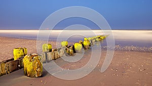 Landscape panorama of old pier posts on the beach