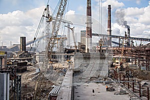 Landscape, panorama, view of factory slums with metal hulls and machines for the production of the coking industry,