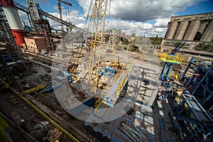 Landscape, panorama, view of factory slums with metal hulls and machines for the production of the coking industry,