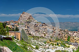 Rock cut Uchisar castle and village at the foothill, Goreme national park, Cappadocia Turkey