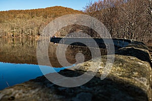 Landscape of pantano de santa fe dam  in catalonia with clear blue sky during autumn season with mountains in the background and photo