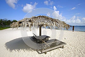 Landscape photo of beach hut in Mabul Island ocean with blue s