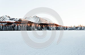 Landscape photo of frozen and snow covered Strba tarn Strbske pleso in winter time. Mountains in Slovakia with frozen lake on