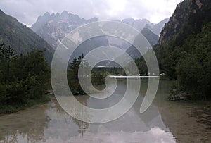 Landscape photo with glossy surface of Lago di Landro lake and mountain in Dolomites, Italy