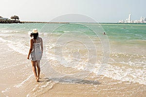 Landscape photo at Palmarito beach on Tierra Bomba island, Colombia. And a female model walking