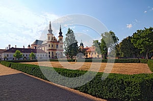 Landscape photo of Piarist Church of the Discovery. View from the park in the Castle Litomysl by summer day