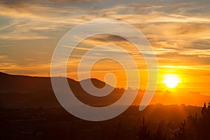 landscape photo of a sunrise over Patagonian hills and Atlantic ocean.