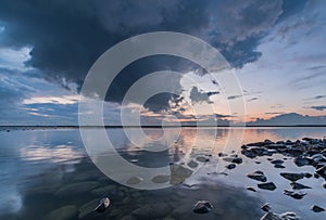 Reflecting lake during sunset with heavy clouds, Ijselmeer Holland