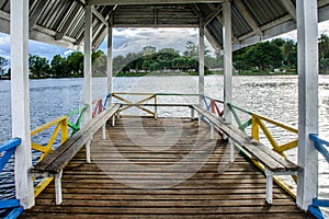 landscape photo of wooden bench on the lake