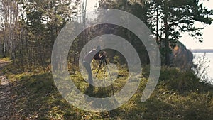 Landscape Photographer with Camera on a Tripod - Female artist taking travel photos in nature