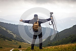 Hiker with camera and tripod enjoying nature
