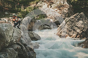 Landscape Photographer Taking Pictures of Scenic Waterfall