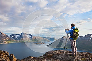 Landscape photographer working with tripod and dslr camera