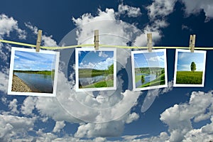 Landscape photographs hanging on a clothesline