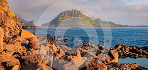 Landscape photography. Misty morning view of Tindholmur cliffs