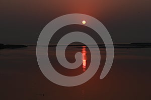 Landscape photography, morning sunrise at beach with round full sun