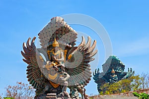 Landscape picture of old Garuda Wisnu Kencana GWK statues as Bali landmark with blue sky as a background. Balinese traditional