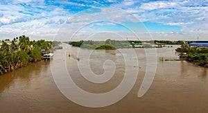 A landscape pictures of the shores of the mekong river in south vietnam near vinh long on a sunny summer day