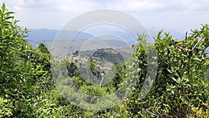 Landscape portrait showing mountains green environment and a village located on the top of mountain in Uttarakhand India