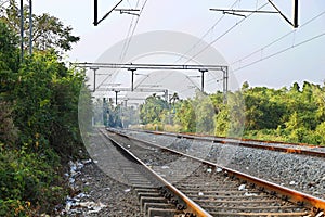 Landscape of railroad tracks in India cutting across rural countryside