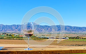 landscape of red wine glass and mountains