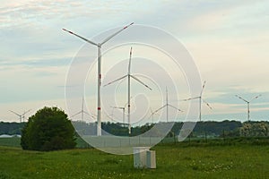 Landscape from renewable energy wind turbine with field, forest and sky