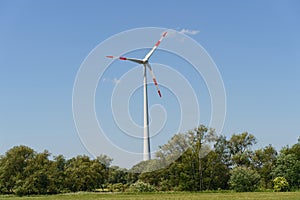 Landscape from renewable energy wind turbine with field, forest and sky