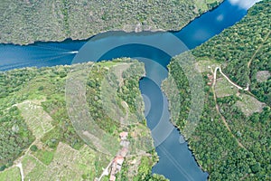 landscape of the Ribeira Sacra, river Sil and a small village on the slope of the mountain, aerial top view with a dron