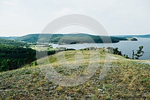 Landscape river cliff grass on the sky background