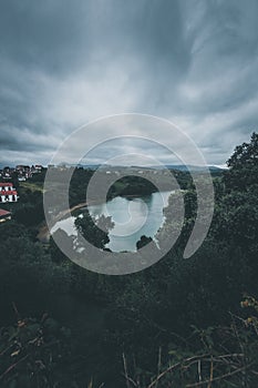 Landscape with the river on cloudy day. Dark sky