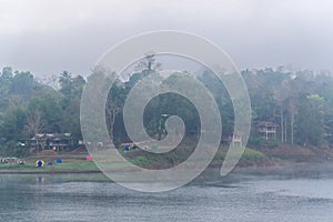 Landscape of river and houseboat with morning mist