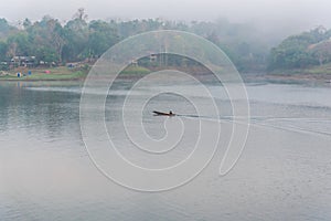 Landscape of river and houseboat with morning mist