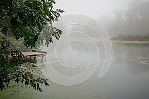 Landscape with a river in the morning mist