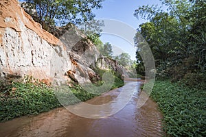 Landscape with river between red rocks and jungle Ham Tien canyon Mui ne