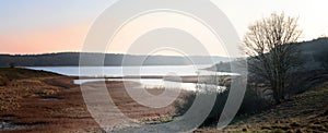 landscape on the river Trave in early spring in the evening light near Luebeck at the Baltic Sea, panoranic banner format