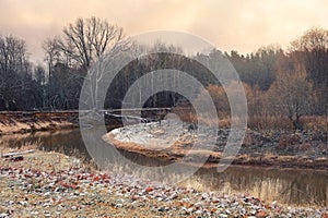 Landscape with a river and trees covered with frost in late autumn