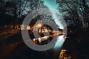 Landscape with river and trees at sunset. Toned image.