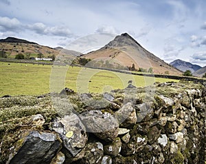Landscape of road alongside Wast Water in Lake District in England with mountains in distance