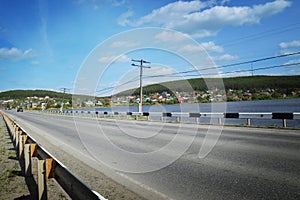 Landscape with road, forest, river and blue sky