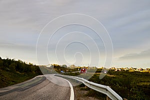 Landscape with road in tundra in Norway at cloudy evening