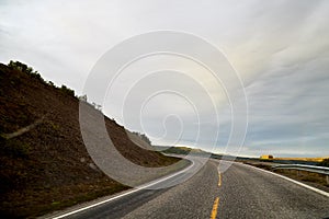 Landscape with road in tundra in Norway at cloudy evening