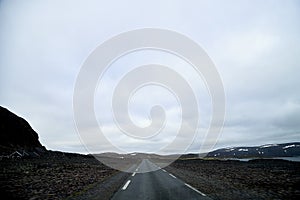 Landscape with road in tundra in Norway at cloudy evening