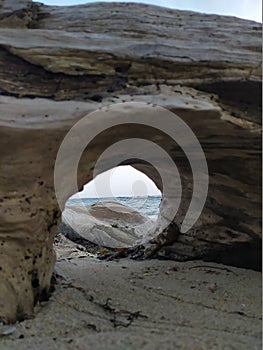 A landscape of sand, stones and sea. Un paisaje de arena, piedras y mar. photo