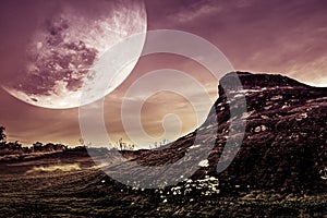 Landscape of the rock with night sky and big moon above wilderness area in forest.