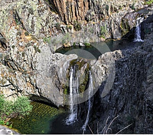 landscape of rock and water at the Aljibe waterfalls photo