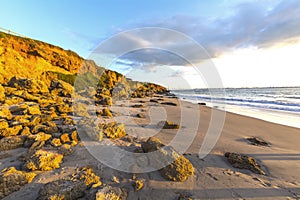 Landscape of rocky beach at sunset photo