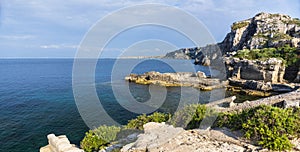 Landscape with rocky coast and bay at sunset